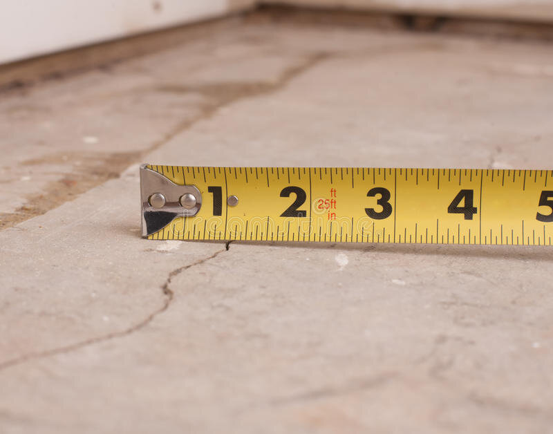 Crack in cement foundation with tape measure